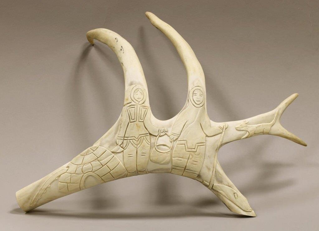 Annie Kanayok (1944) - a carved antler depicting a Northern Scene (Two Figures near an Igloo