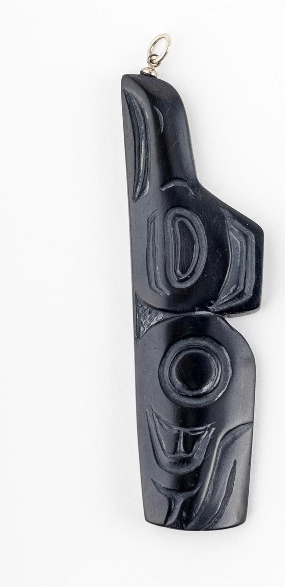 Greg White - a carved argillite pendant depicting Raven