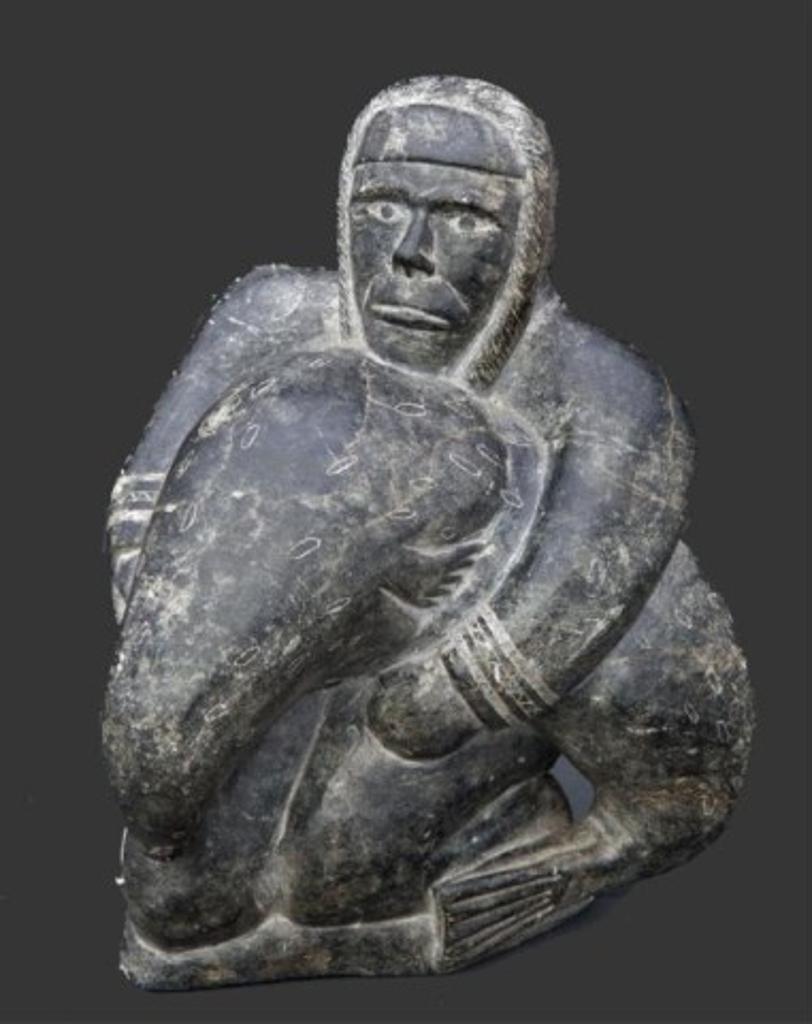 Ittuq Ainaliapik Ainalik (1935) - An incised green/ grey stone carving of a hunter with seal