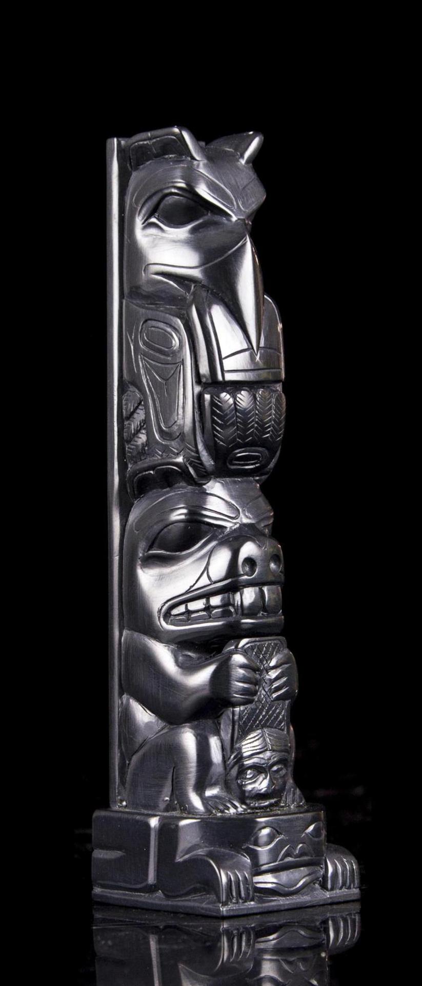 Tom Hans (1925) - a carved argillite two figure totem pole