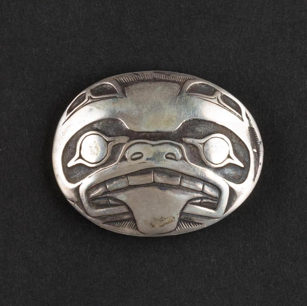Carmen Goertzen - an oval silver belt buckle depicting Haida Bear