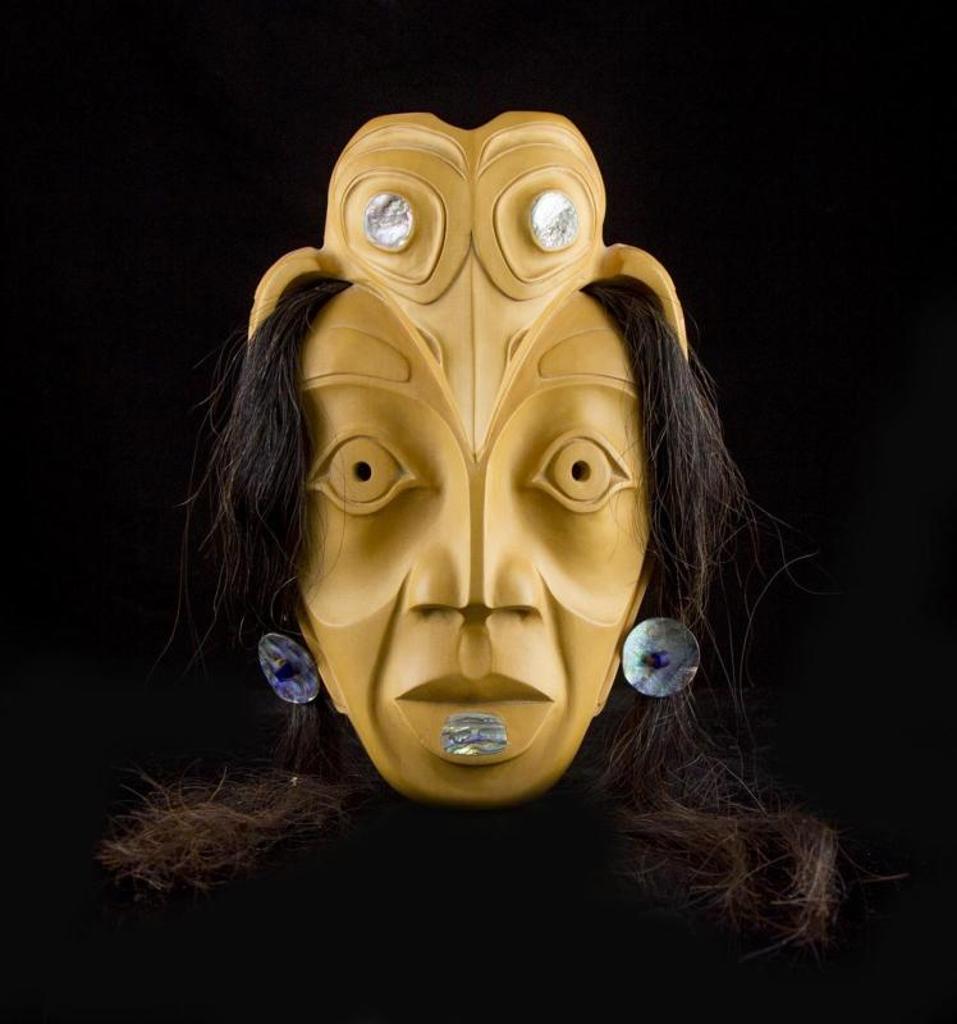 Jimmy George - a carved yellow cedar mask titled Raven Woman