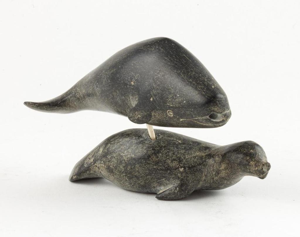 Nauja - a black stone carving of a beluga atop a seal