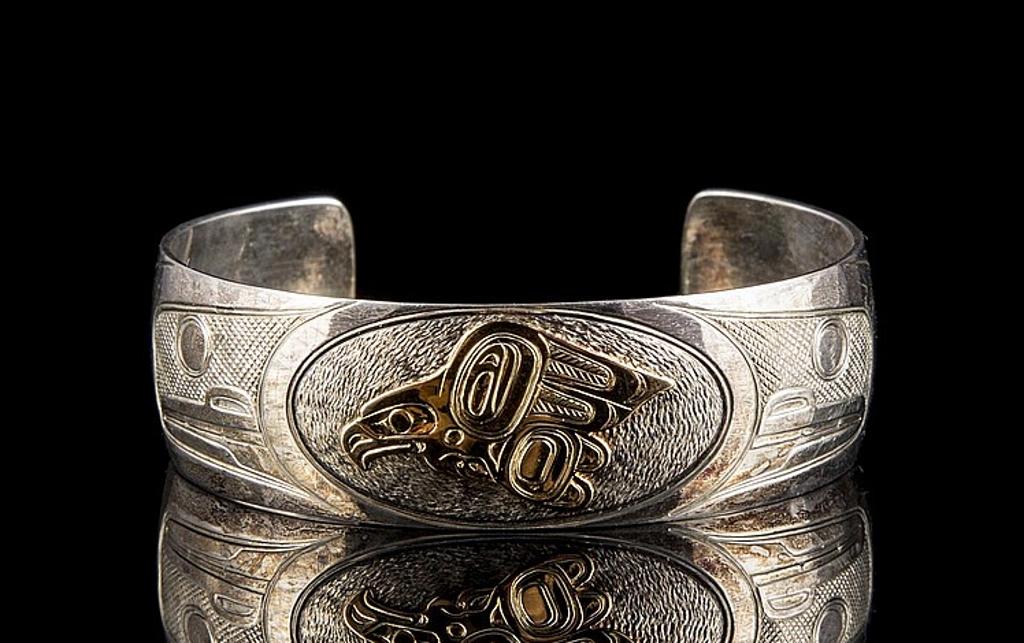 Tim Boyko - a silver and 14kt yellow cuff bracelet depicting Raven and Frog