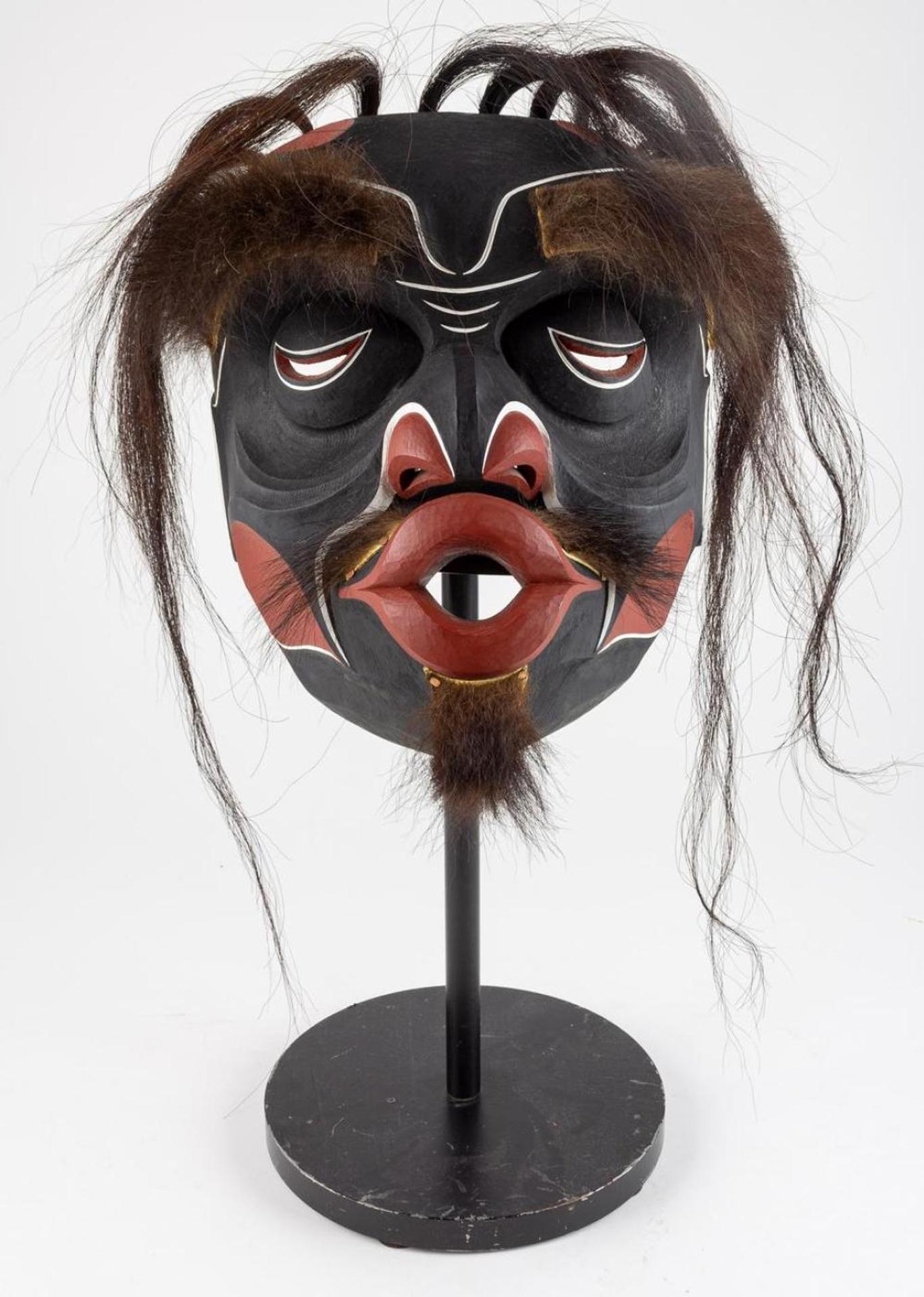Tom Hunt - a carved and polychromed cedar Tsonokwa mask trimmed with hair