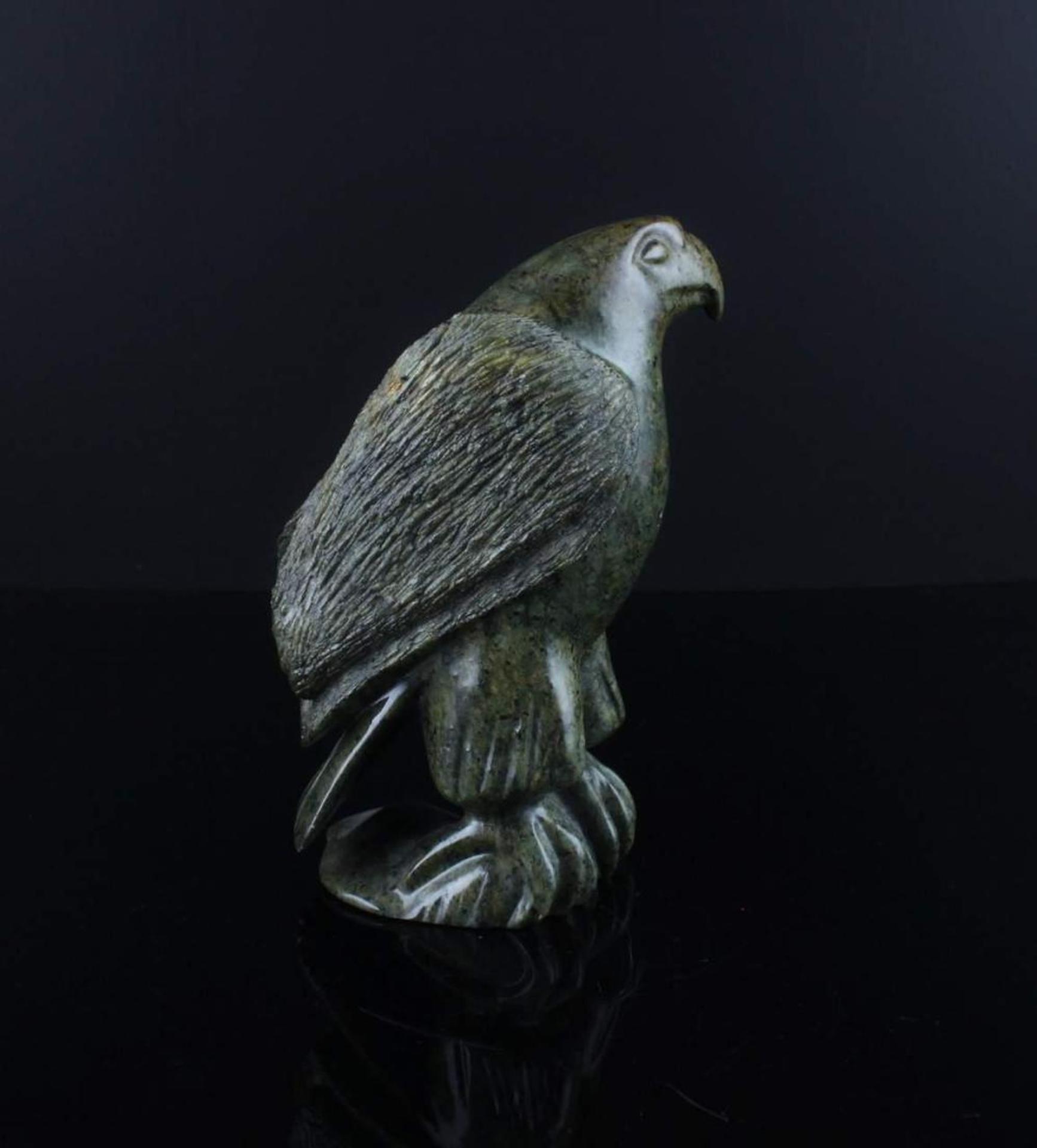 Floyd Grossetete - a green stone carving of a hawk