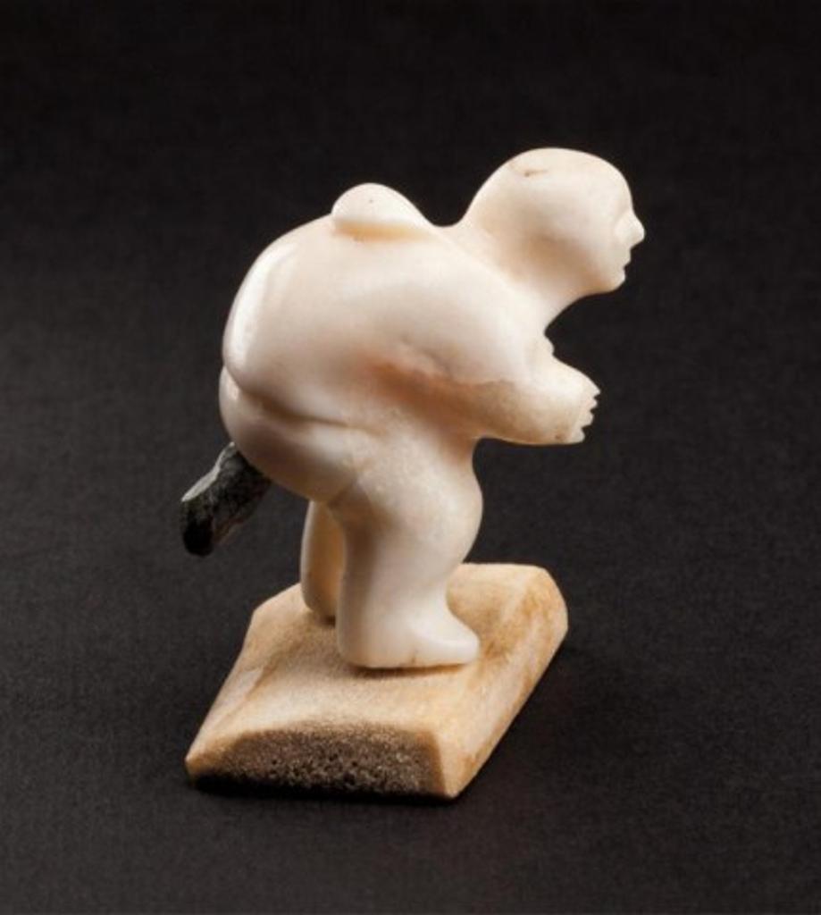 Maria Niptayuq (1943) - Man defecating, 1981, ivory, stone and bone, 1.375 x 1.125 x 1.125 in, 3.5 x 2.9 x 2.9 cm