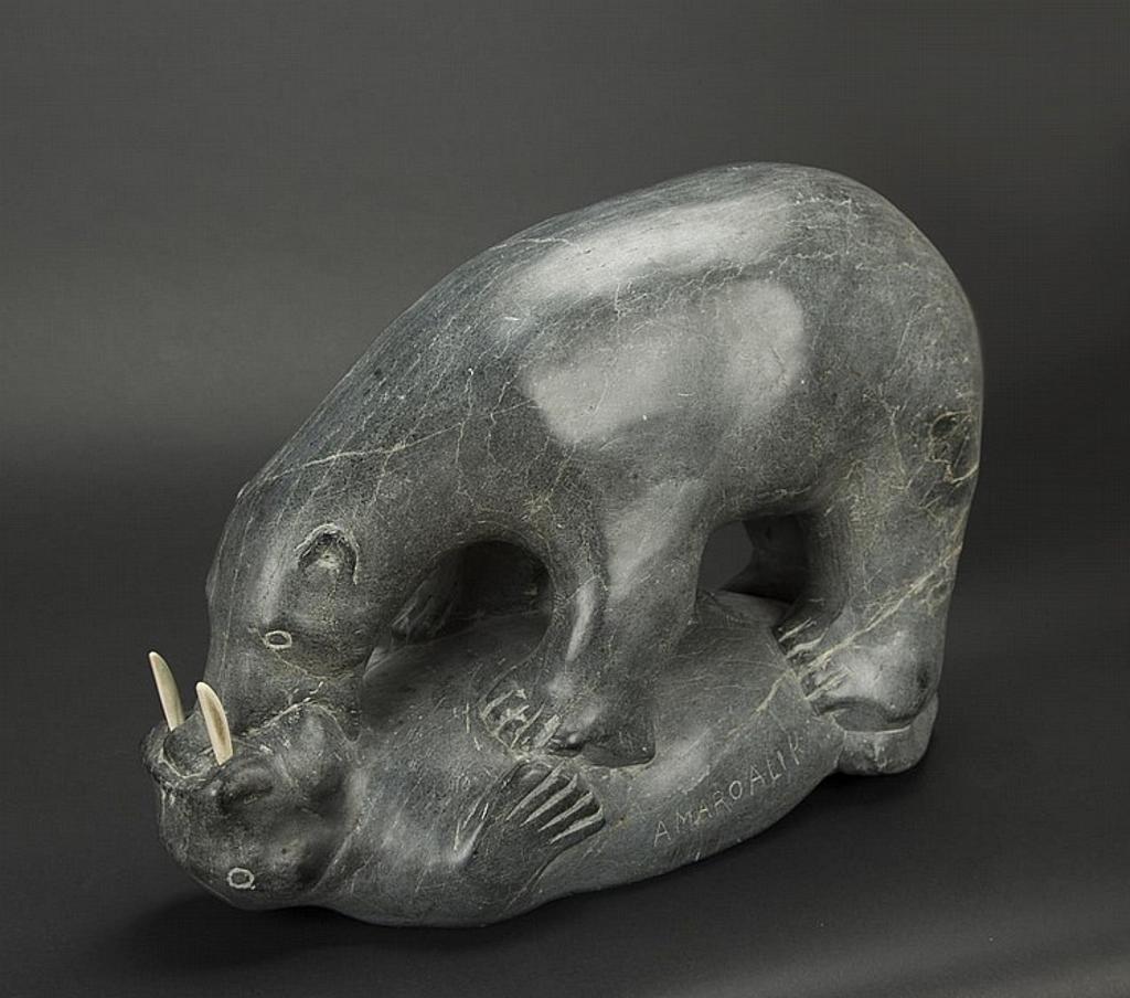 Amahoalik - a grey soapstone carving of a bear fighting a walrus