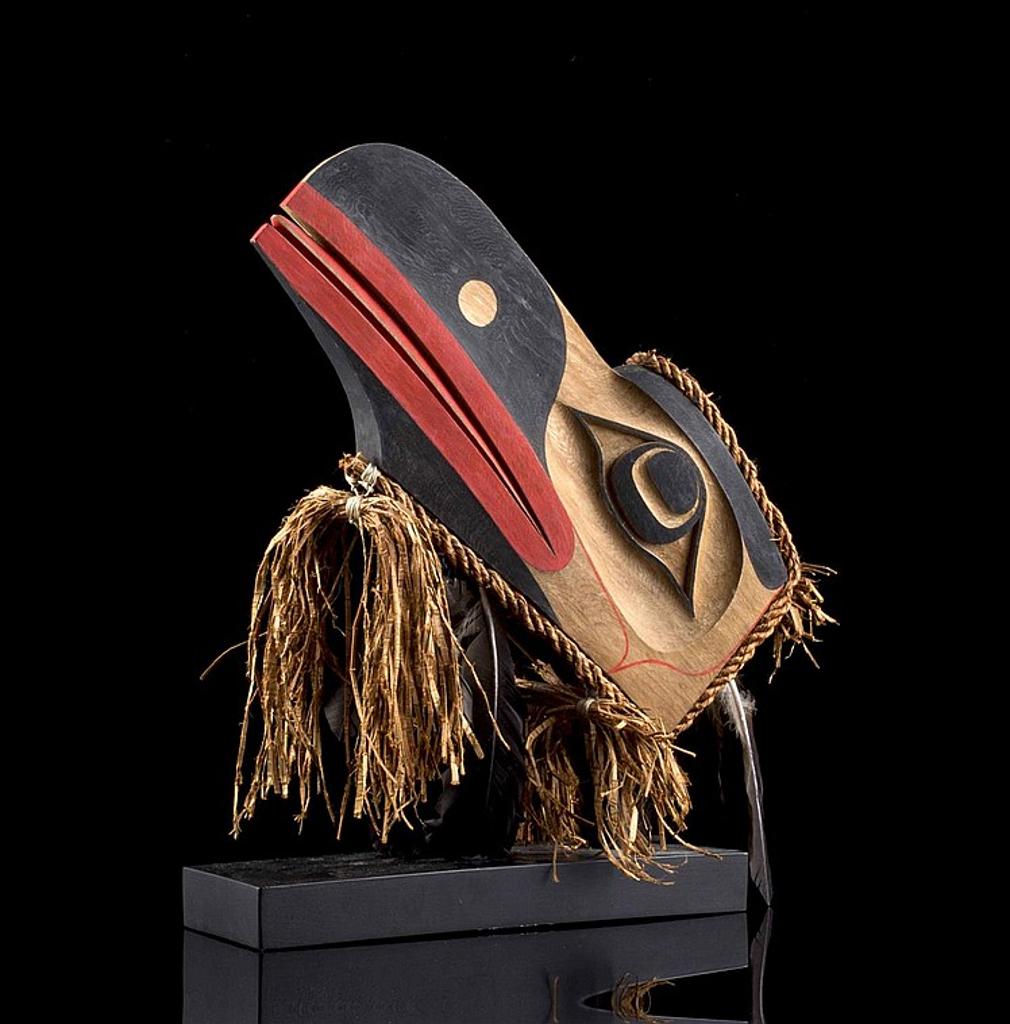Jay Simeon (1976) - a carved and polychromed red cedar Raven mask decorated with cedar strips and feathers