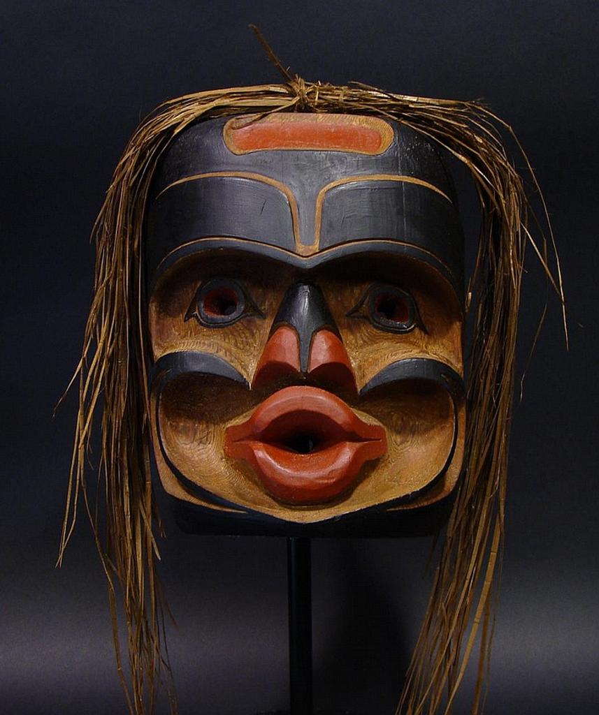 Oscar Matilpi (1933-1999) - a carved and polychromed red cedar Tsonokwa mask with cedar strip hair
