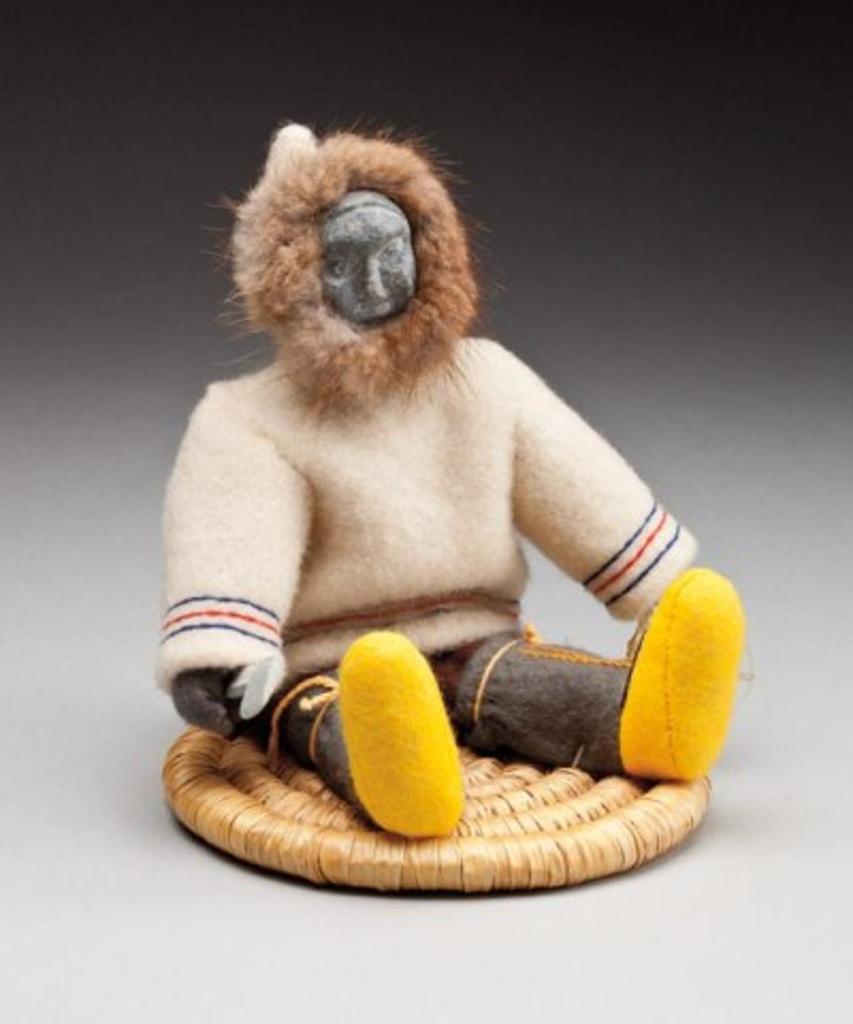 Annie Niviaxie (1930-1989) - Doll depicting a seated male with an axe, ca. 1975, stroud, felt, stone, fur, thread and sinew on a woven grass base, 7.75 x 7.25 x 7 in, 19.7 x 18.4 x 17.8 cm