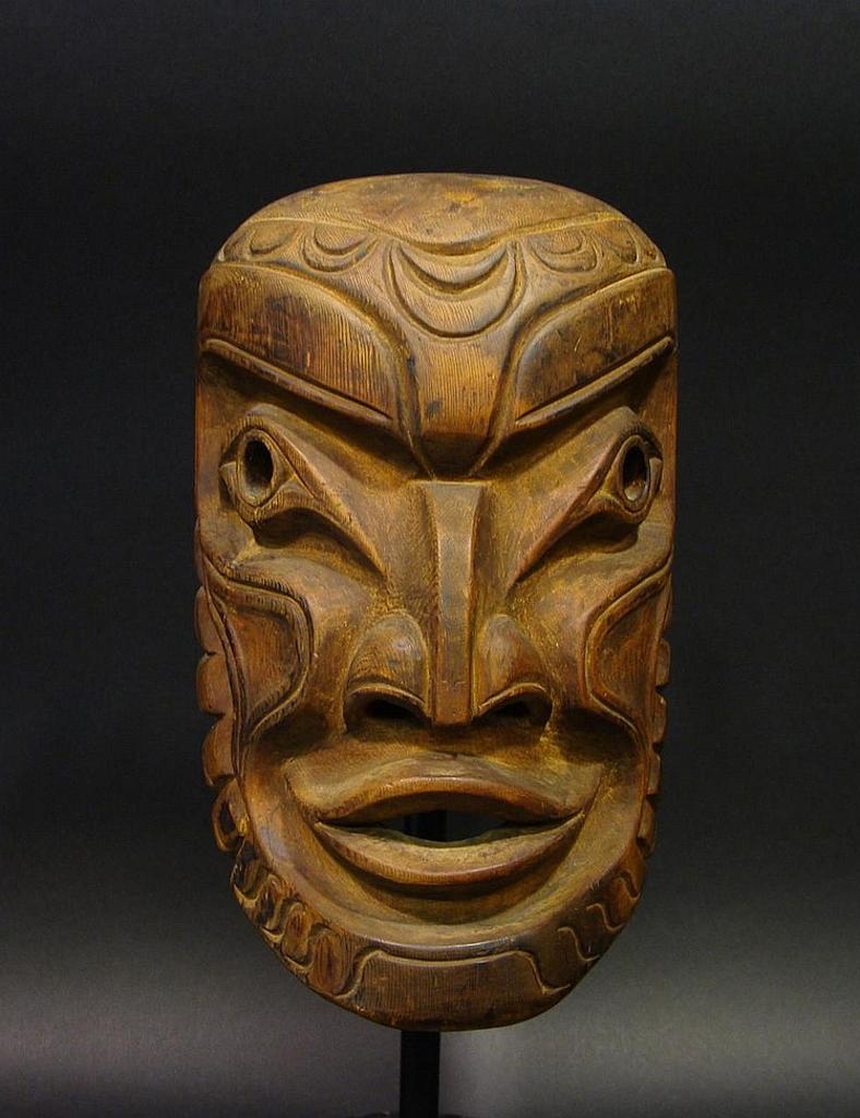 James Dick - a carved and stained yellow cedar Kumugwe mask