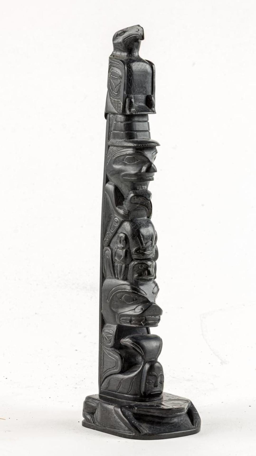 Rufus Moody (1923-1998) - a carved argillite pole depicting Eagle