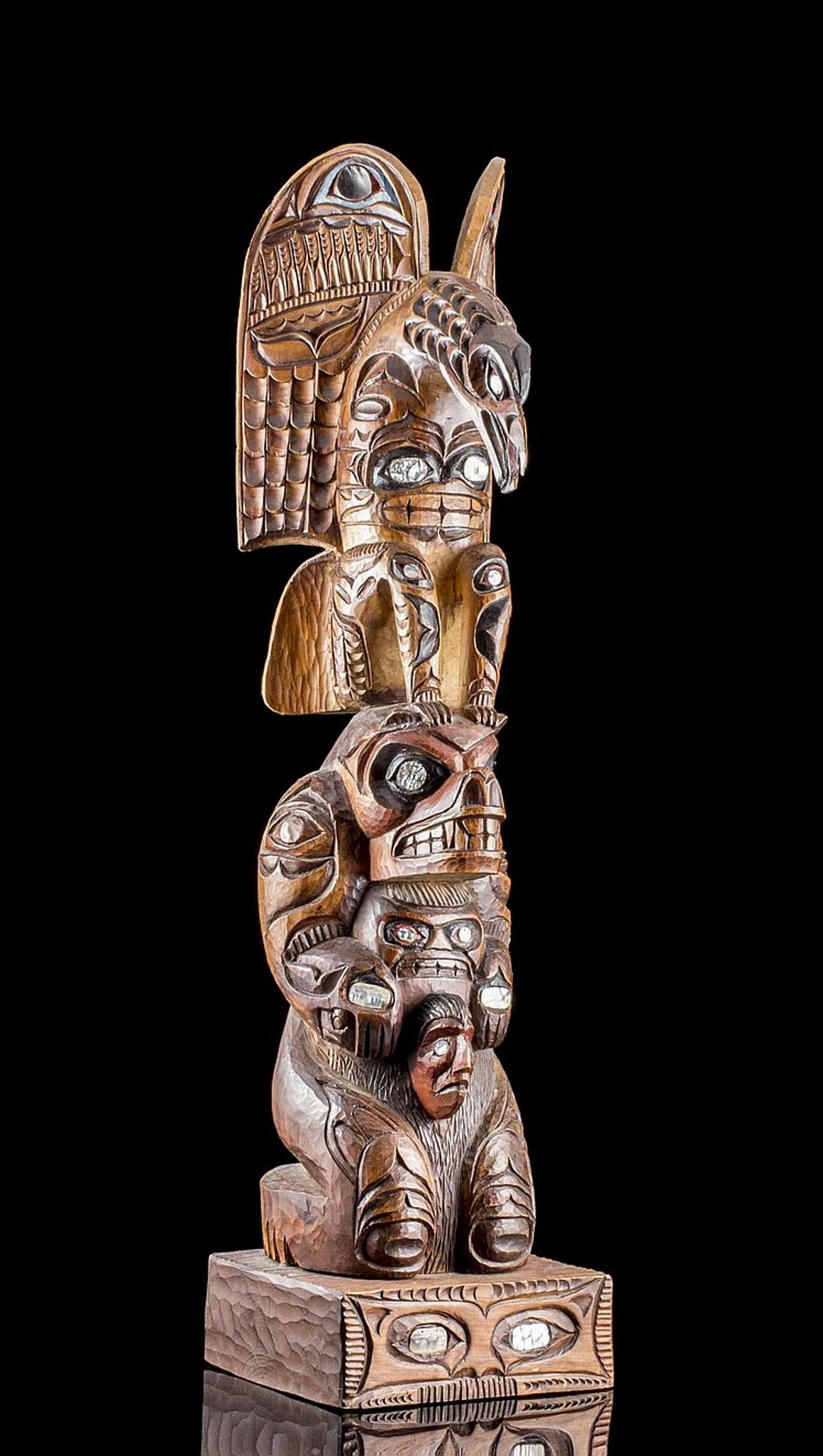 Leslie John - a carved and stained cedar totem pole depicting Eagle and Bear with abalone inset in their eyes