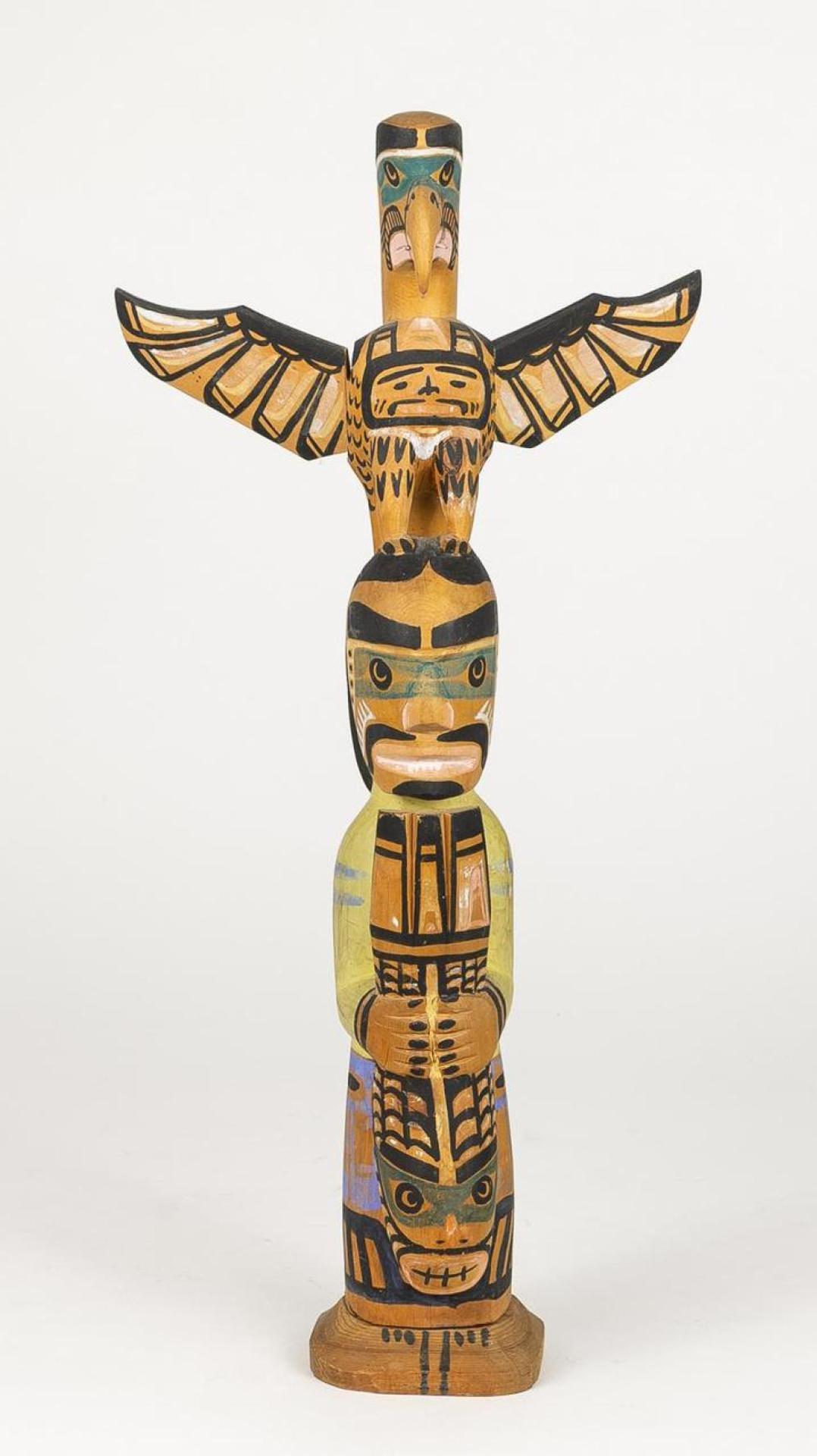 Charlie James (1865-1961) - a carved and polychromed totem pole depicting Thunderbird above Man holding Seal