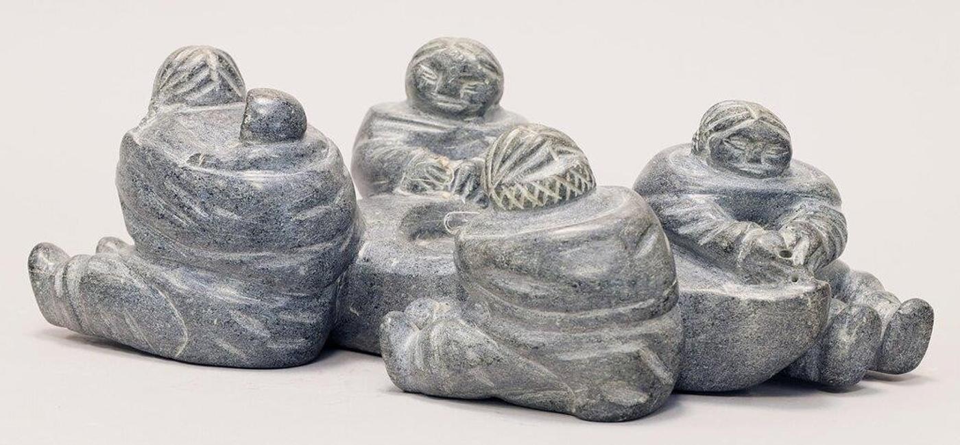 Evie Tullaugaq Qamugaaluk Koperquacuk (1925) - A grey stone carving of Four Women and a Kayak, dated Novembre 1980 on the underside