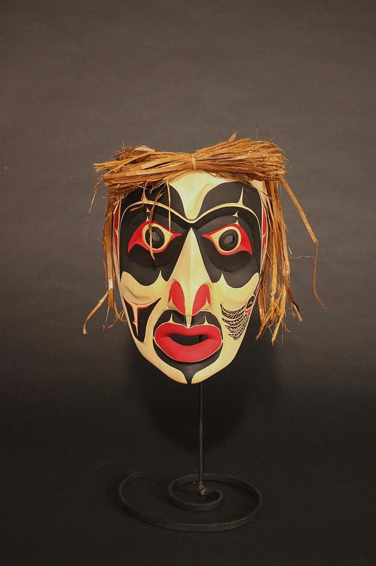 Gerald Thibert - a carved and polychromed mask depicting Raven transforming to Man