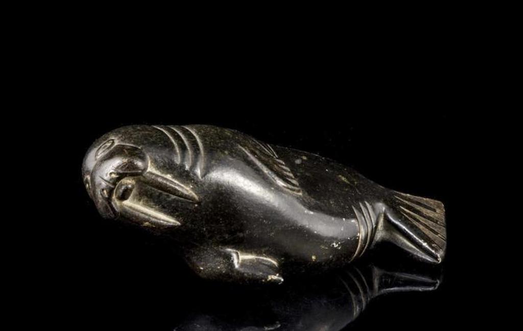 Jimmy - a black stone carving of a walrus lying on its side