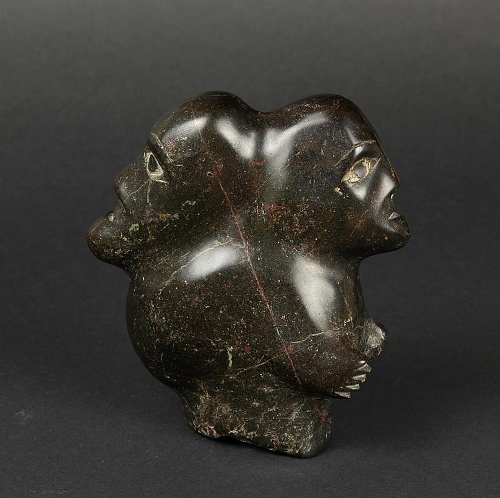 Nauja - a black stone carving of two faces