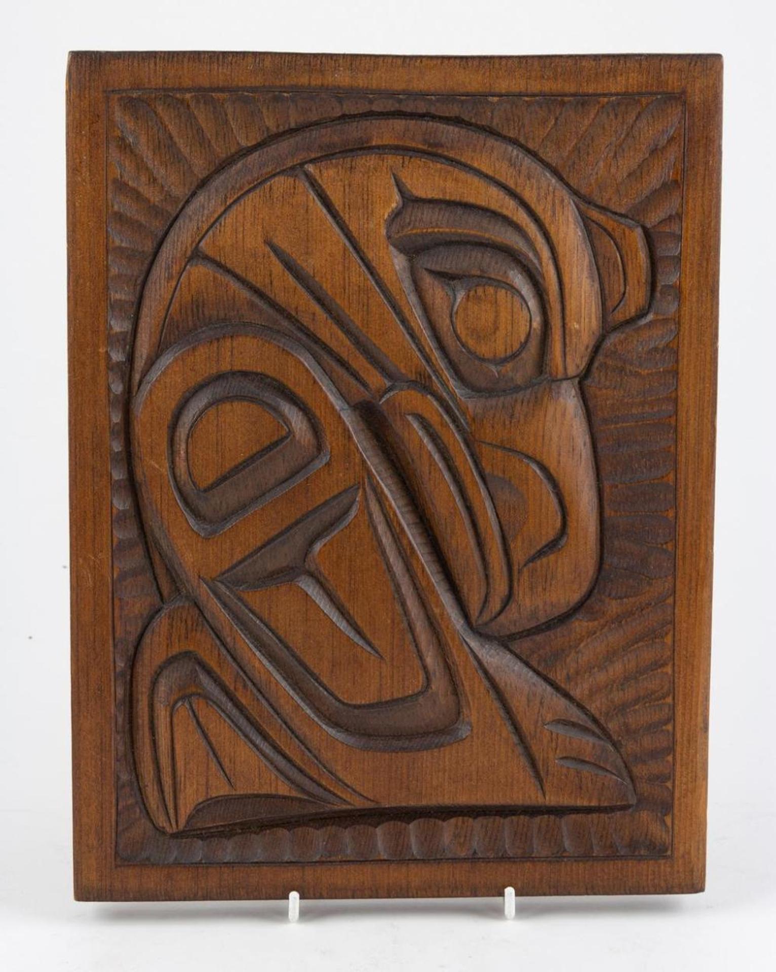 George Matilpi (1953) - a carved and stained cedar plaque depicting Kwakiutl Raven