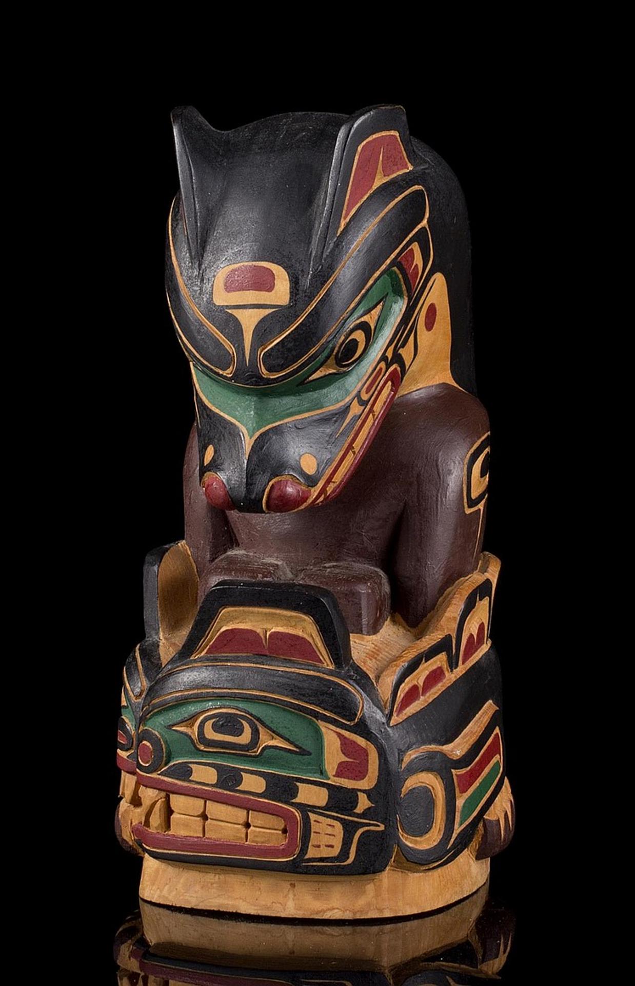 Henry Hunt (1951) - a carved and polychromed two figure pole depicting Wolf above Sisuitl