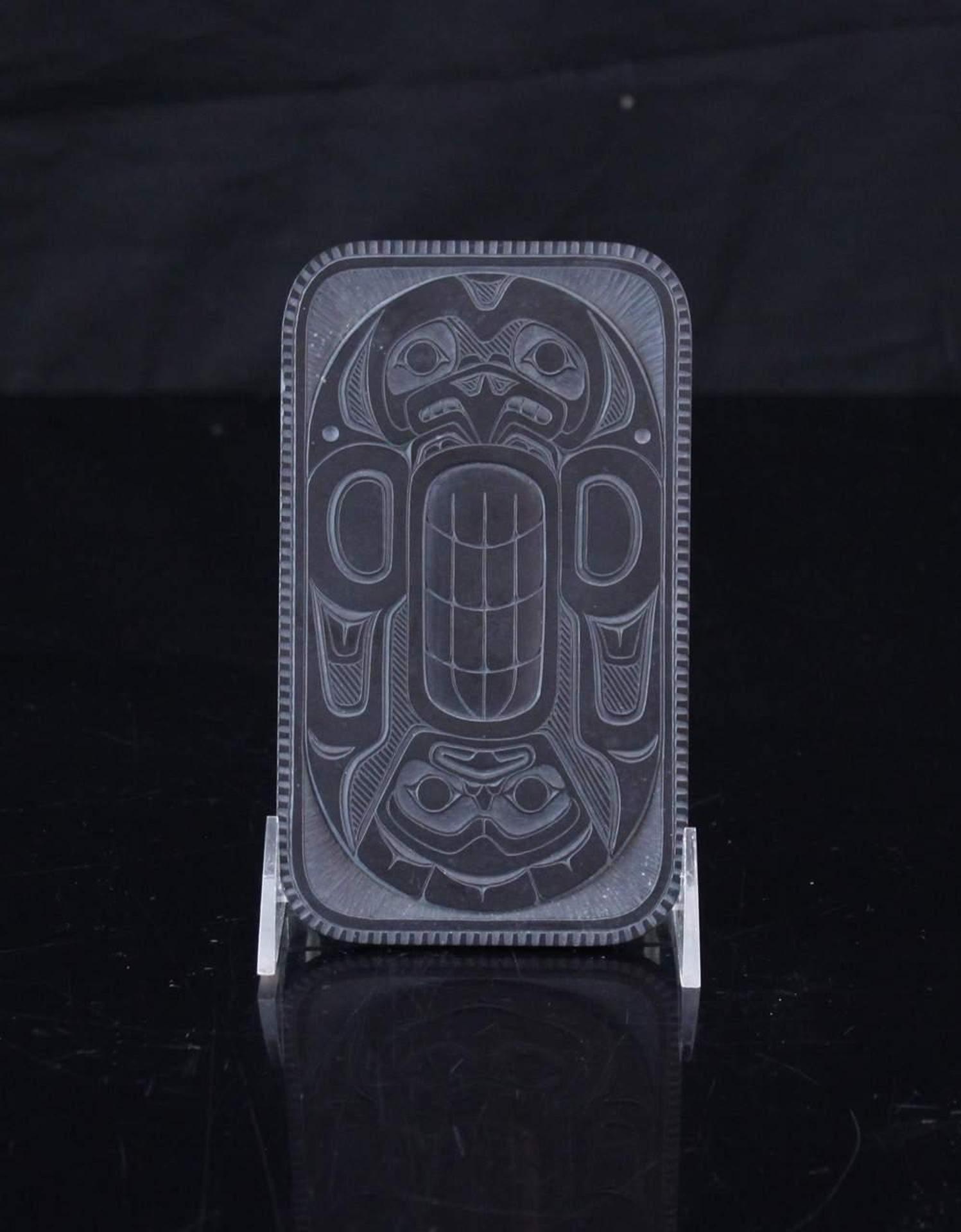 Denny Dixon (1944) - a rectangular carved argillite plate decorated with an image of Haida Thunderbird