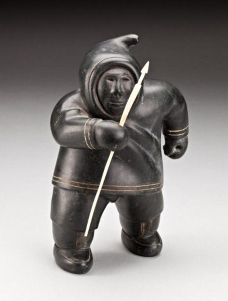 Akeeaktashuk (1898-1954) - Walking hunter, ca. 1950-53, black stone, ivory and inlay, 10 x 6.5 x 5.5 in, 25.4 x 16.5 x 14 cm