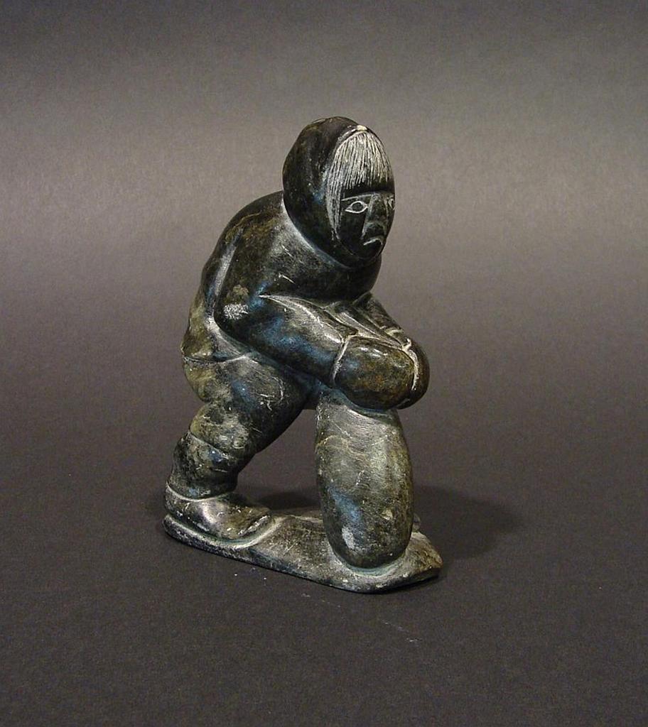 Willie Nappatu - Akulivik a small soapstone carving holding a bag