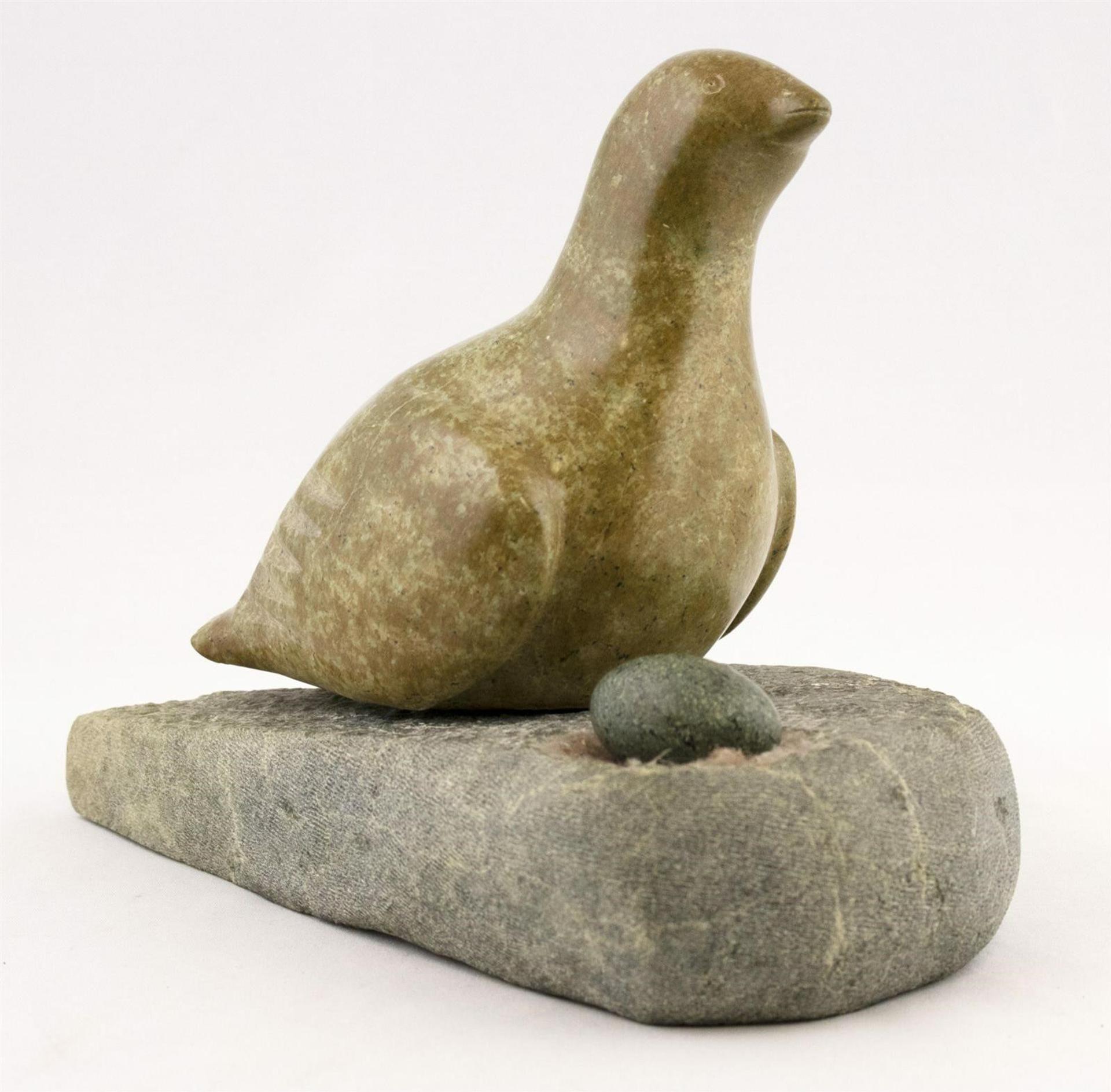 Martha Nungiugapik Tikivik (1950) - a serpentine and green stone carving of a Nesting Bird Guarding an Egg; with igloo card