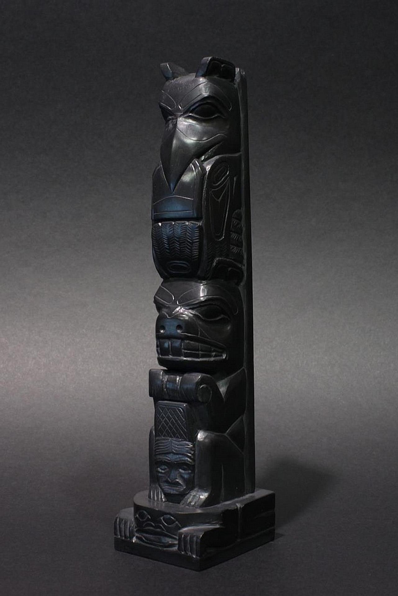 Tom Hans (1925) - a carved argillite two figure totem pole