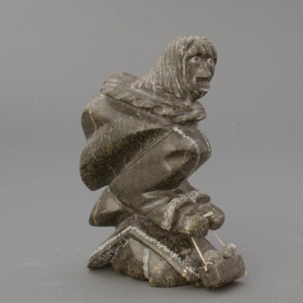 Adamie Sharky (1964) - Green stone carving of a woman kneeling holding a basket of eggs,