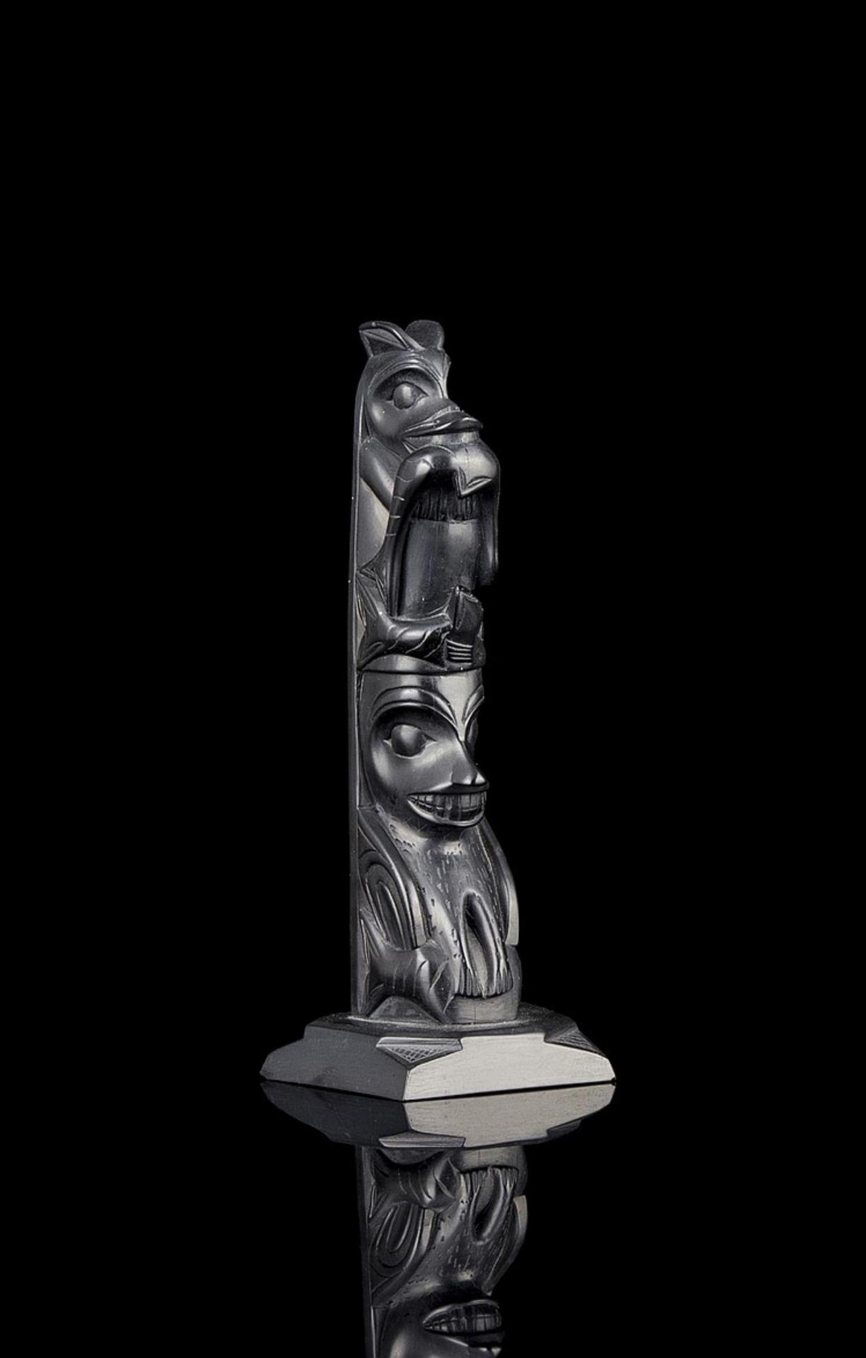 Rufus Moody (1923-1998) - a carved argillite two figure pole