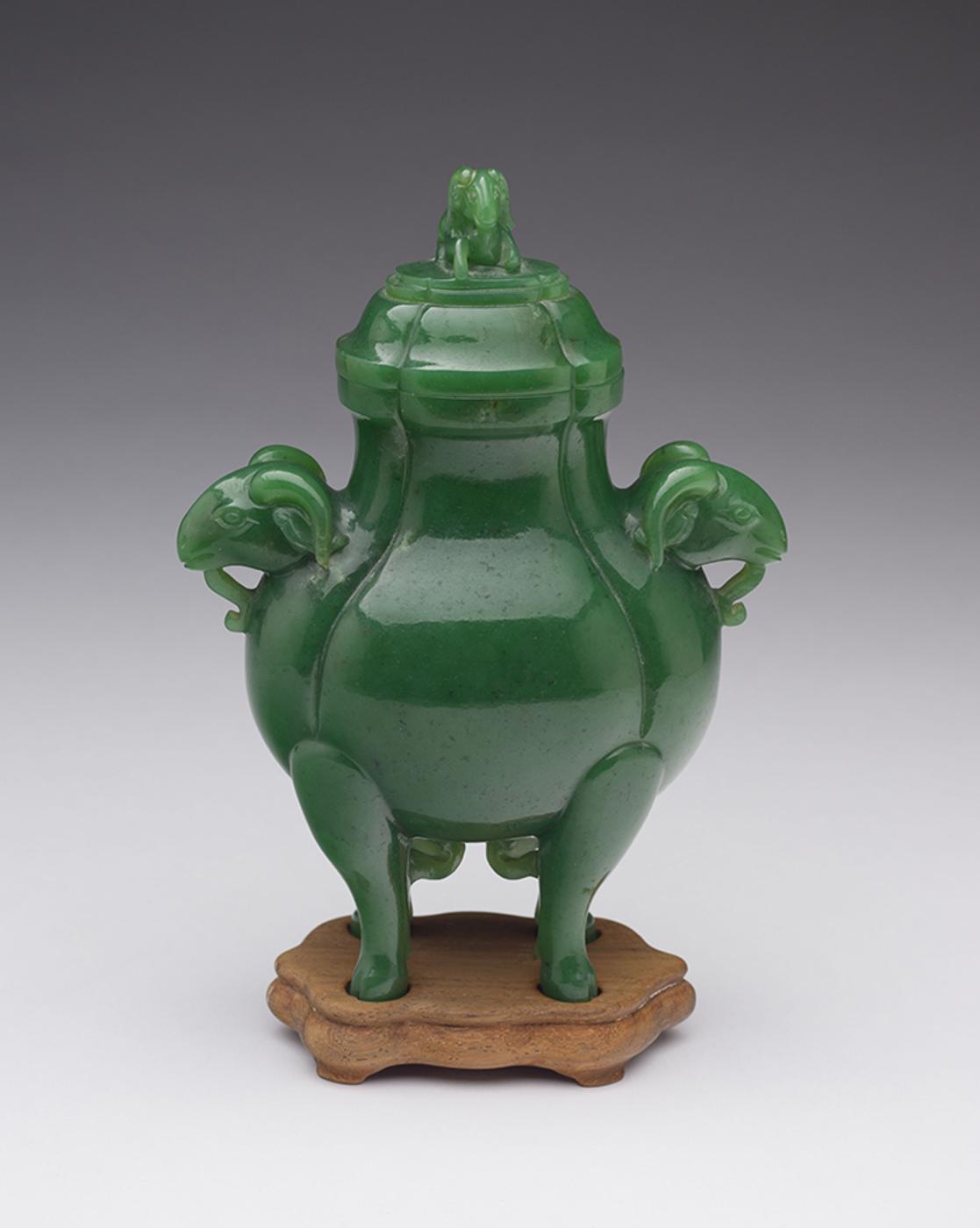 Chinese Artist - A Chinese Spinach Green Jade 'Rams Head' Vase and Cover, Qing Dynasty