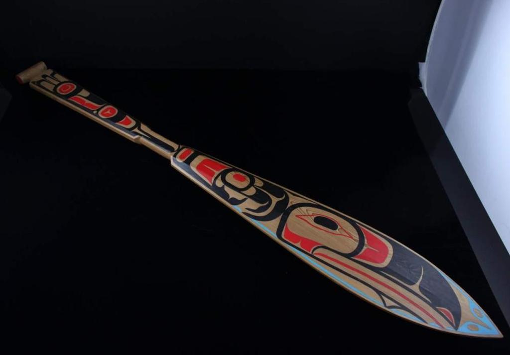 Dalbert Weir - a carved and polychromed paddle decorated with Raven design.