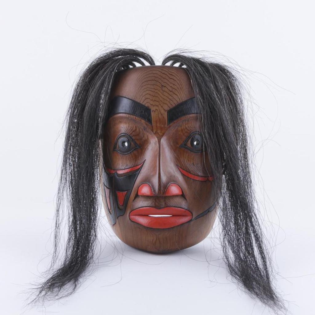 Rocky O'Brie - a carved and polychromed cedar Tsimshian Woman mask.