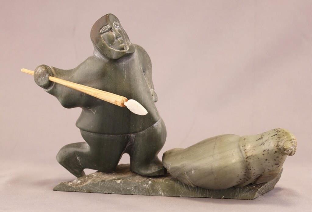 Davidee Kavik (1915) - a light green stone carving of a Hunter (with bone and wood spear) and Walrus