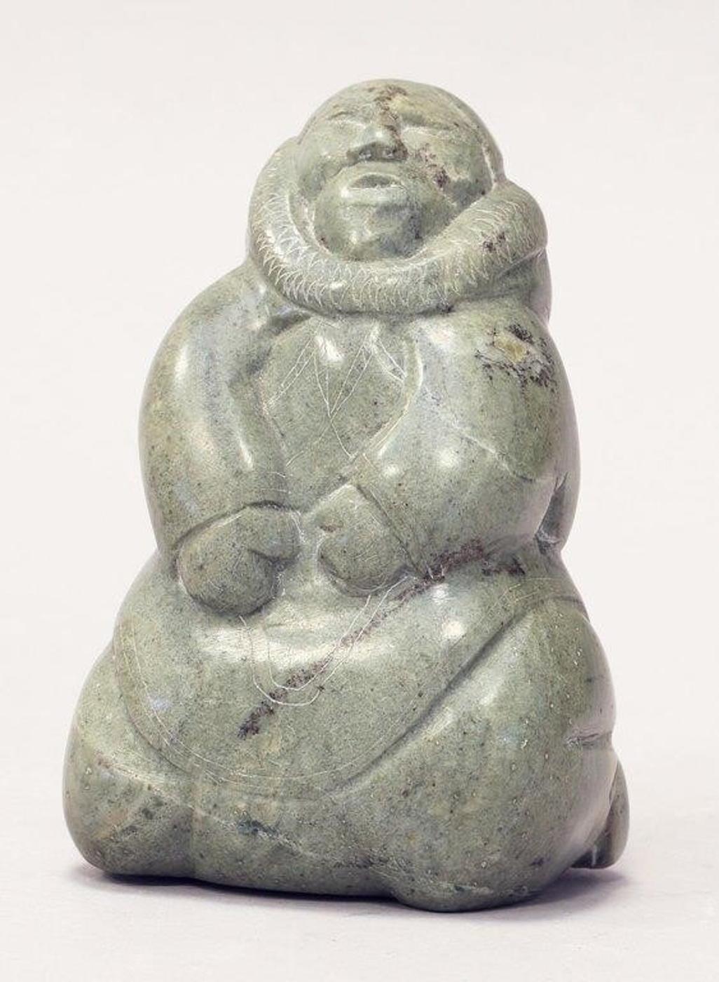 Annie Novalinga (1951) - A light green stone carving of a Woman