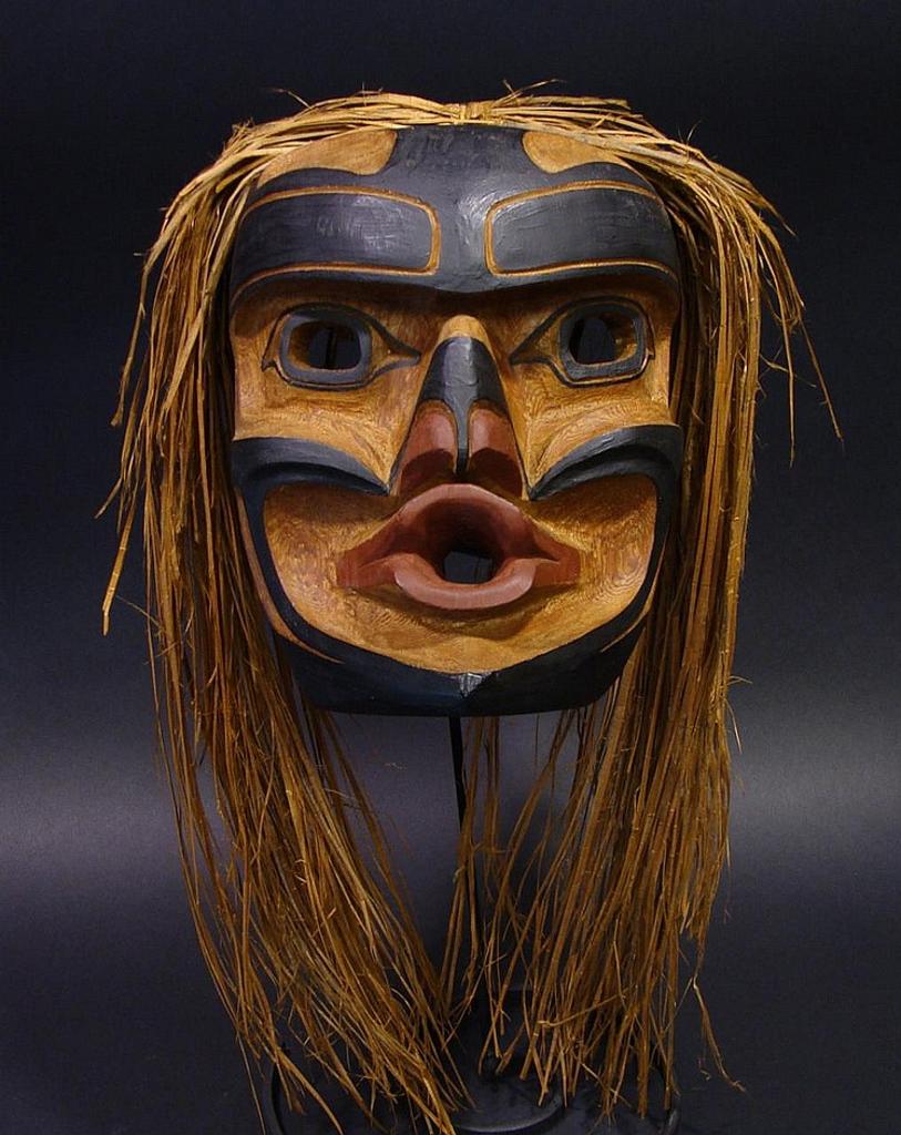 Henry Hunt (1951) - a carved and polychromed red cedar Tsonokwa mask with cedar strip hair
