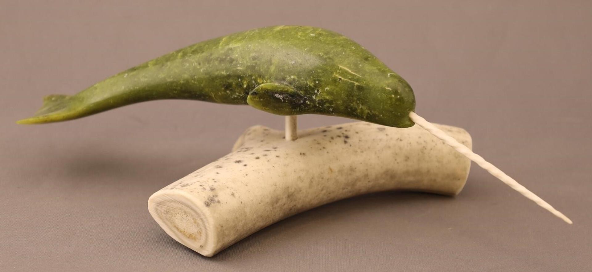 Eegetsuak Ejetsiak Pitseolak (1947) - a serpentine carving of a Narwhal with a bone tusk