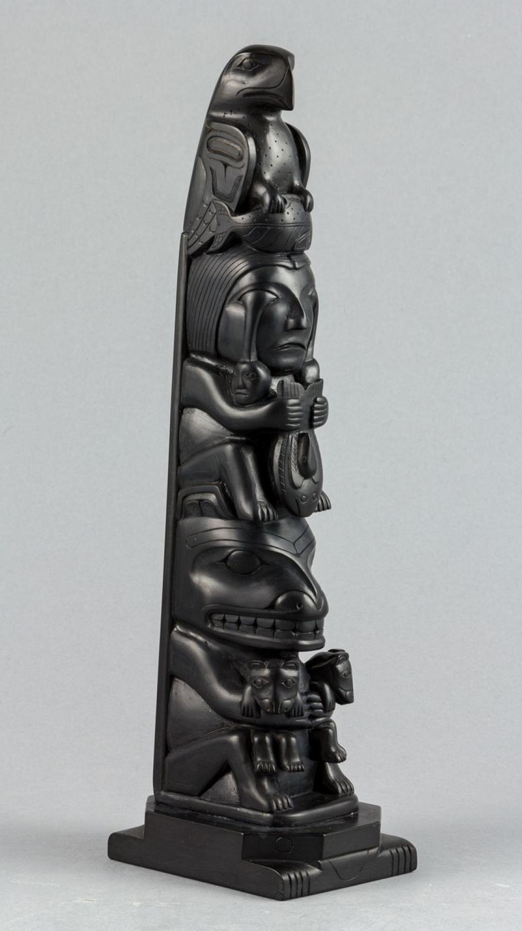 Isaac Hans - a carved argillite totem pole depicting Eagle holding Salmon