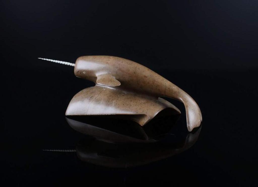 Floyd Grossetete - a brown stone carving of a narwhal
