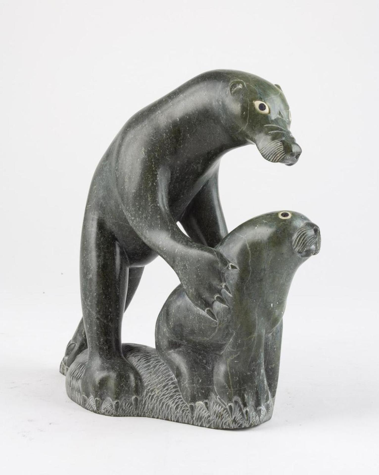 Simiuni - A green stone carving of a polar bear catching a seal