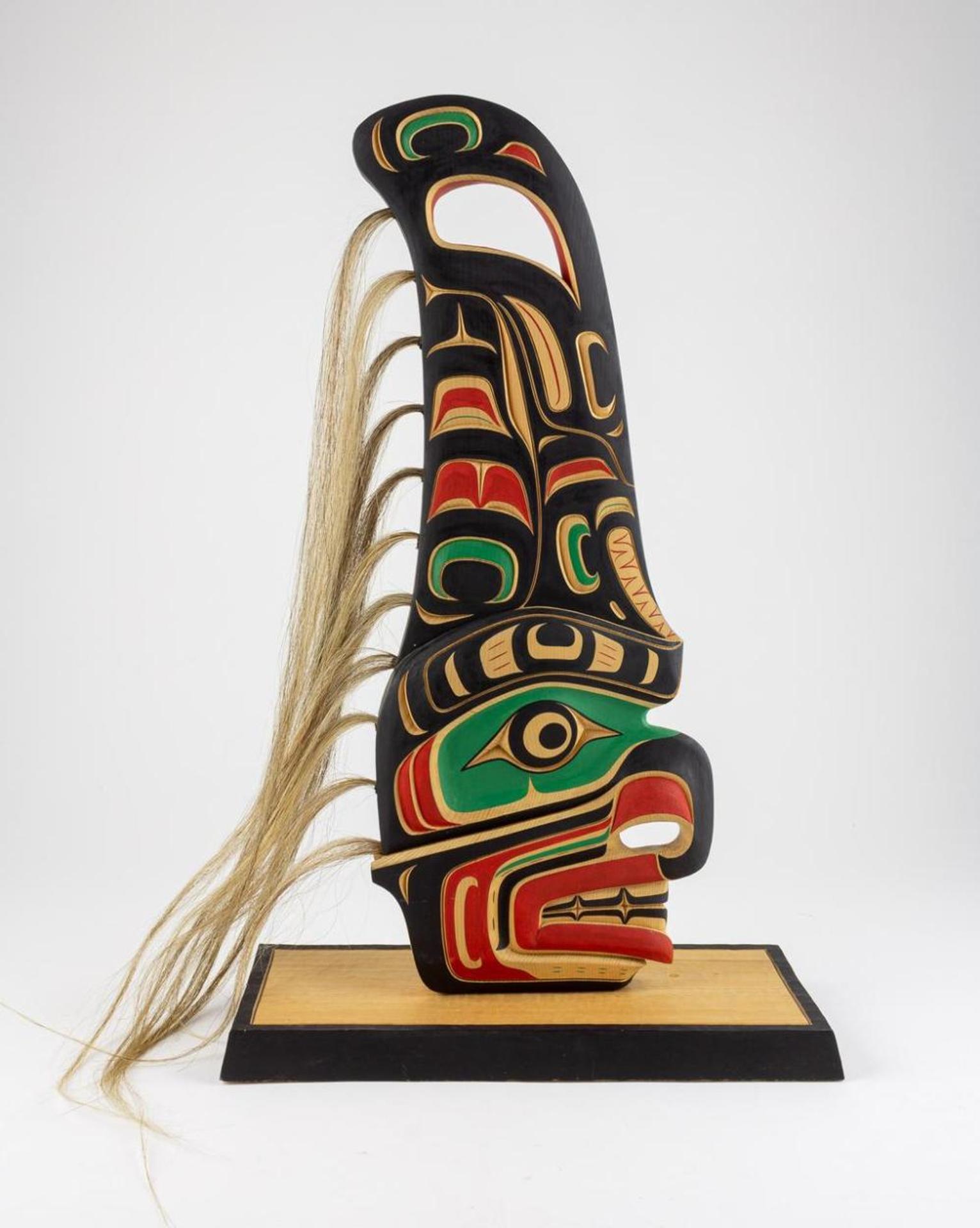Tom Hunt (1964) - a carved and polychromed cedar Dorsel fin - Hawk man and Killer whale design