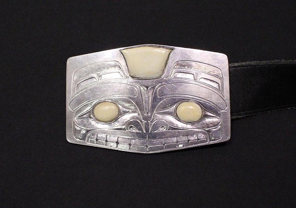 George Yeltatzie - a silver belt buckle with Haida Bear design and having ivory inlays