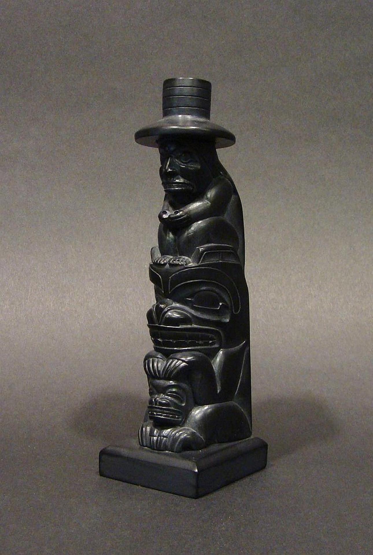 Garner Moody (2006) - a carved argillite model pole depicting Human atop Bear