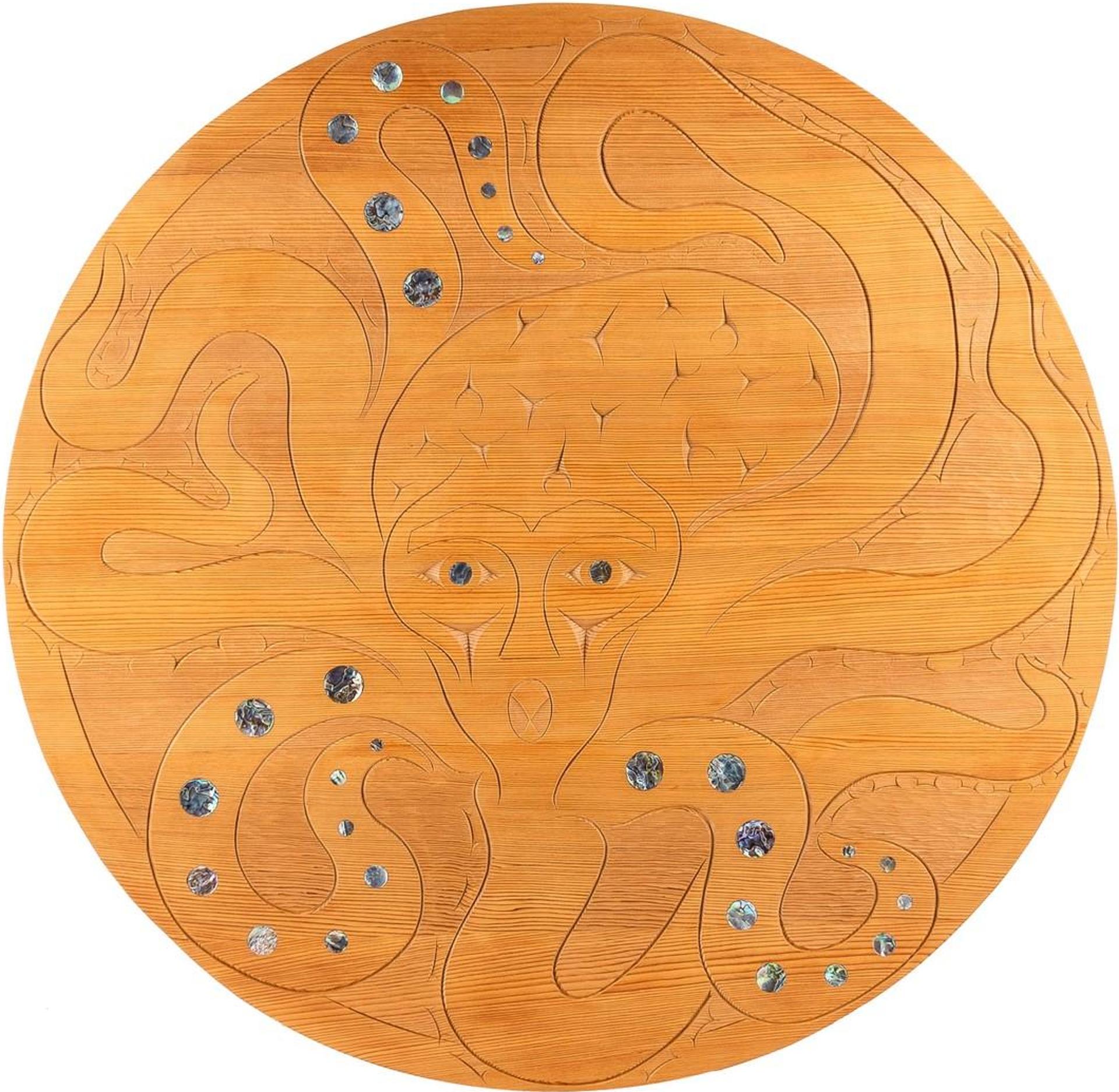 Gerry Sheena - a round carved cedar panel with abalone inlays titled 
