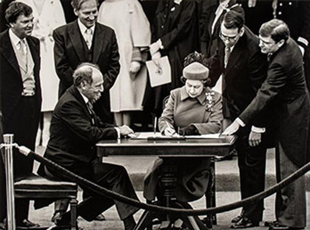 Ron Poling (1950) - The Queen signs Canada’s constitutional proclamation in Ottawa on April 17, 1982 as Prime Minister Pierre Trudeau looks on