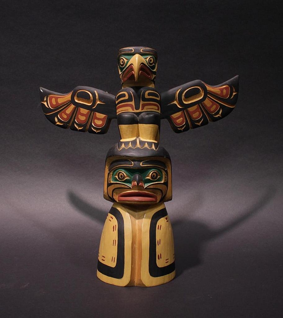 Tony Sr. Hunt (1942-2017) - a carved and polychromed model pole depicting an Eagle atop a Human