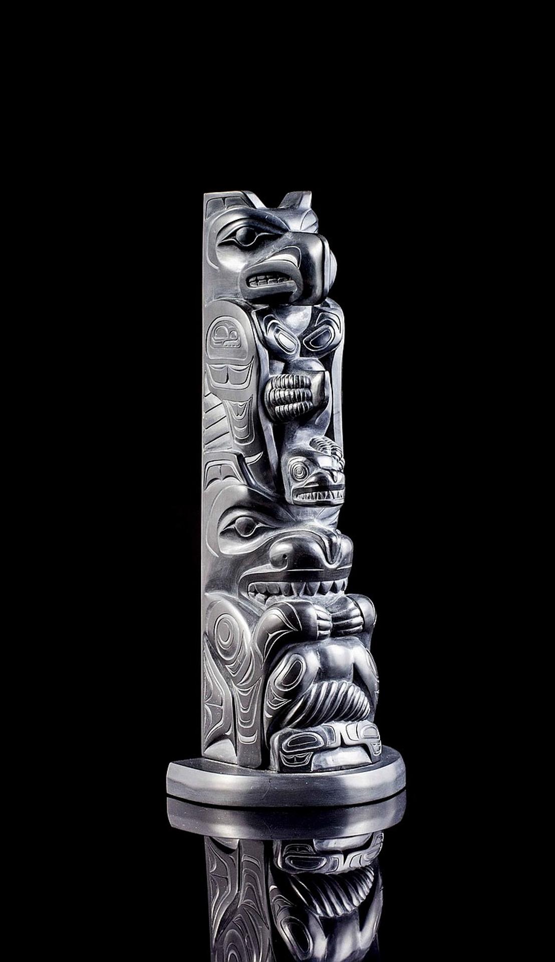 Garner Moody (2006) - a carved argillite pole depicting Thunderbird holding Killerwhale above Sea Bear