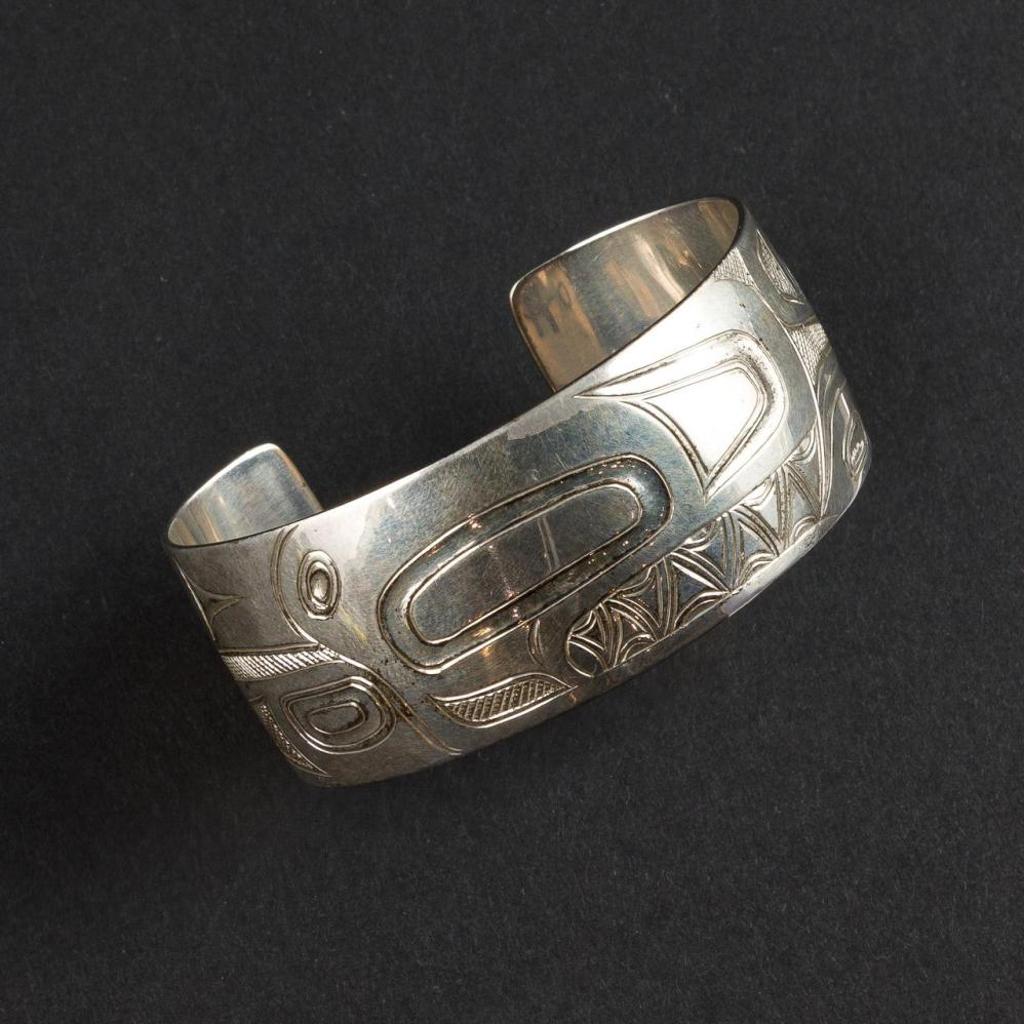 Lawrence Wilson - a carved silver cuff bracelet depicting Killer Whale